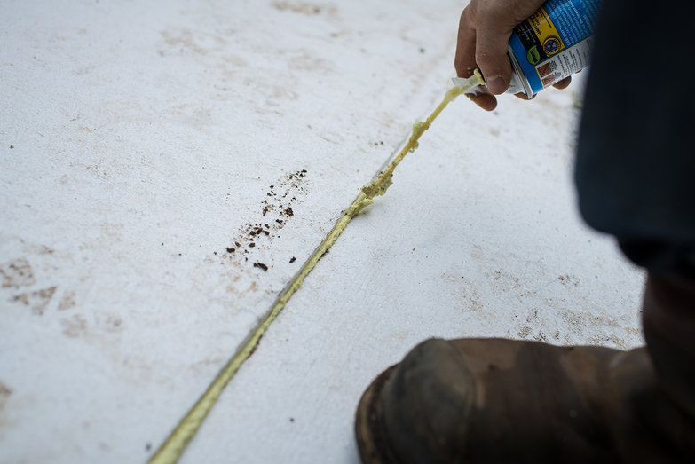 Tyler Applying Disgusting Minimally Expanding Foam to Frost Protected Slab Insulation