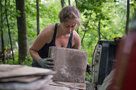 Tara Picking Up Stack of Slate
